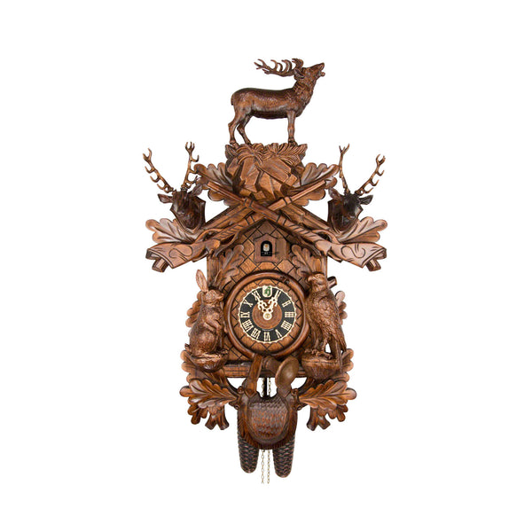  Cuckoo Clock - Carved 8-day hunting style cuckoo clock with large stag, mounted stag heads, rifles, fürst pless horn, rabbit, falcon, and game bag 52cm by Hönes - Cuckoo Collections