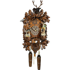 Carved hunting-style battery-powered musical cuckoo clock with stag head, hunter and ibex 42 cm by Trenkle Uhren