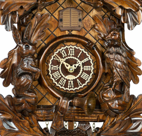 Carved style quartz cuckoo clock with bird in flight & hunter theme 42 cm by Trenkle Uhren