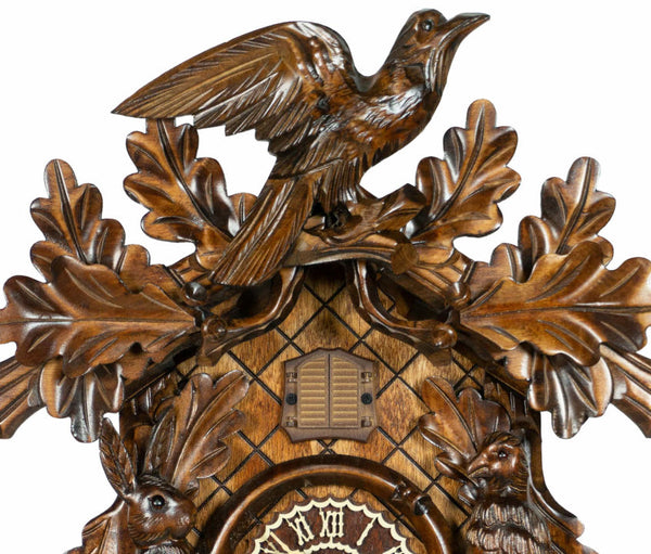 Carved style quartz cuckoo clock with bird in flight & hunter theme 42 cm by Trenkle Uhren
